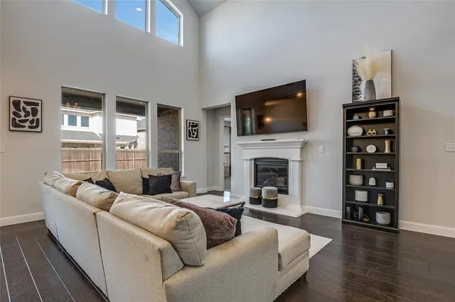 a spacious bedroom with a bed and a flat screen tv