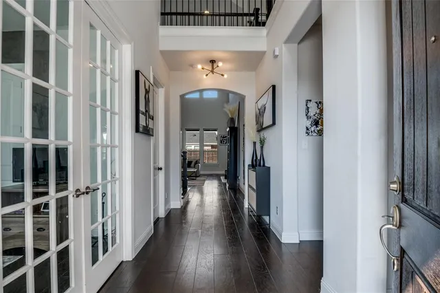 a view of a hallway with wooden floor and staircase