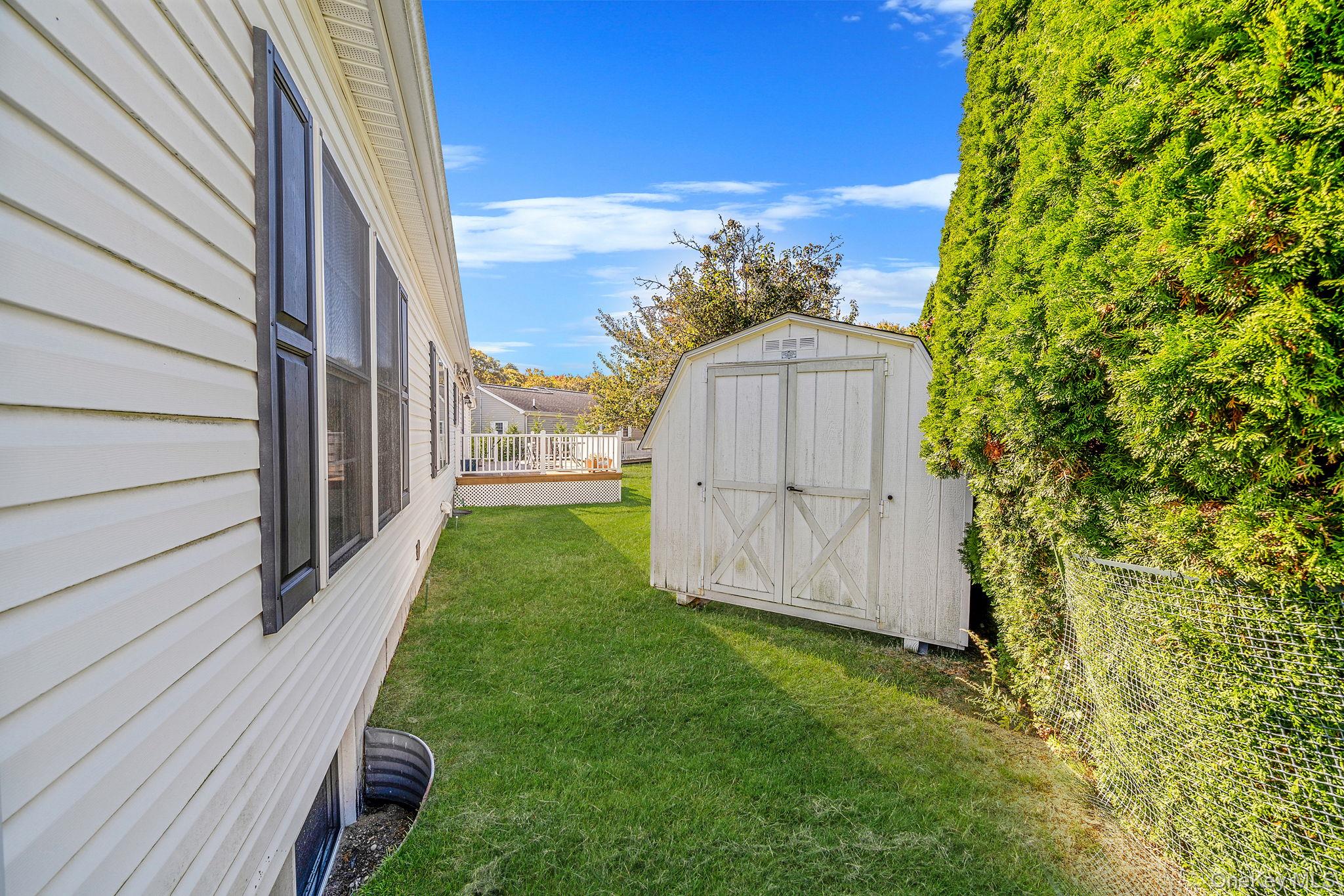 1407 Middle Road, Unit 258 Calverton, NY 11933 - Photo 11 of 50 a view of a house with a backyard