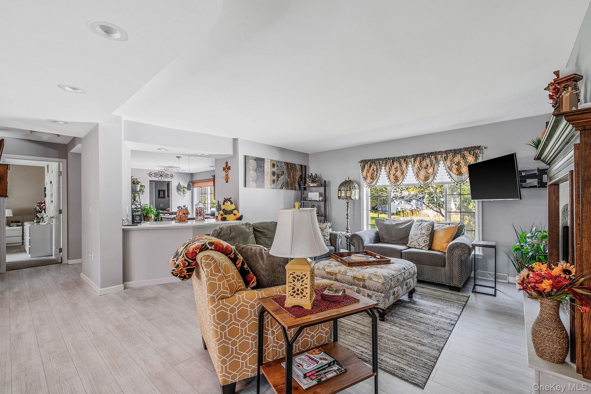 1407 Middle Road, Unit 258 Calverton, NY 11933 - Photo 17 of 50 a living room with furniture or couch and a floor to ceiling window