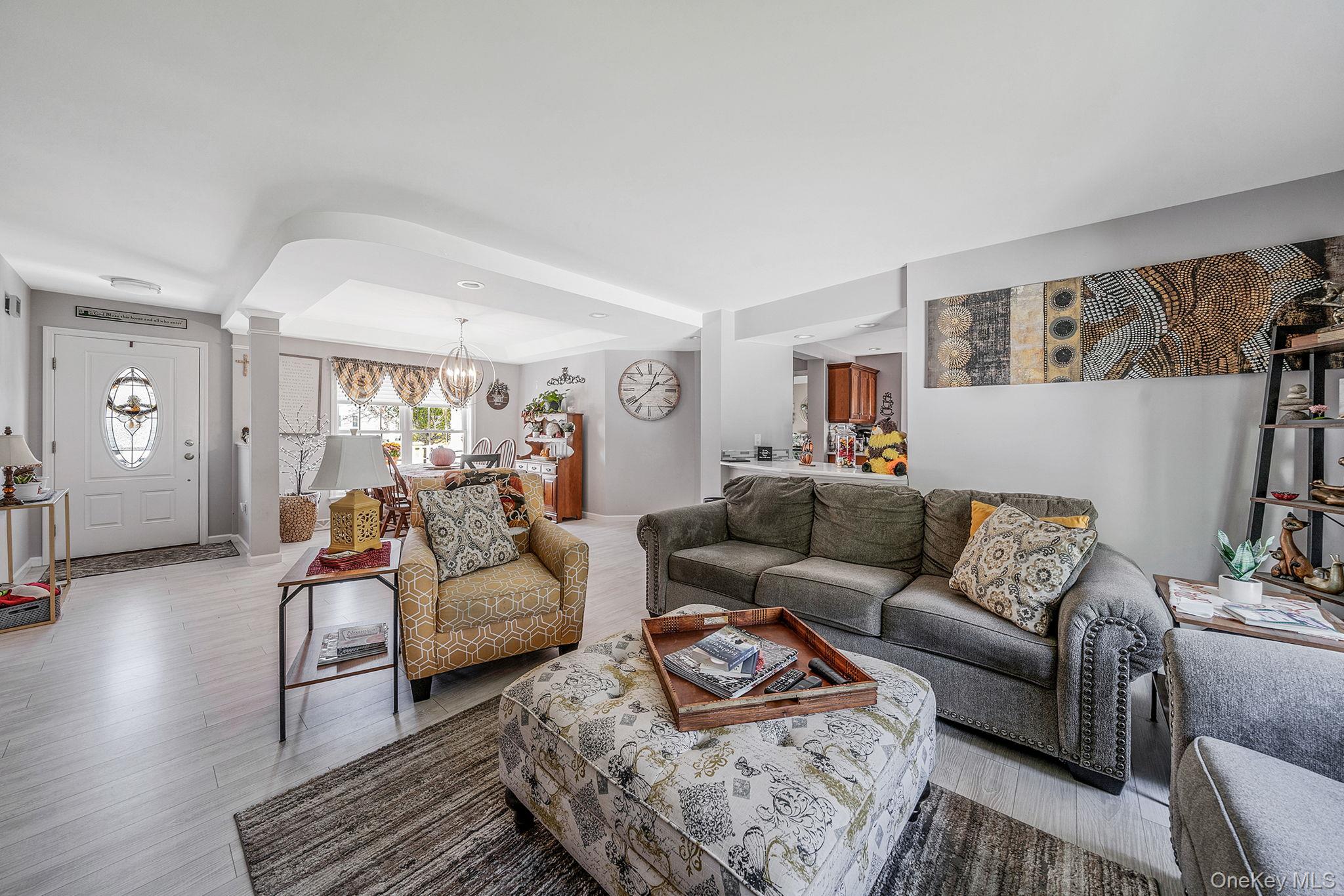 1407 Middle Road, Unit 258 Calverton, NY 11933 - Photo 18 of 50 a living room with furniture and wooden floor
