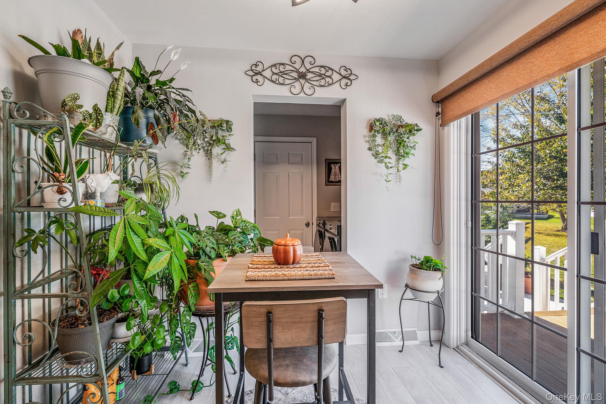 1407 Middle Road, Unit 258 Calverton, NY 11933 - Photo 24 of 50 a view of a dining room with furniture window and outside view
