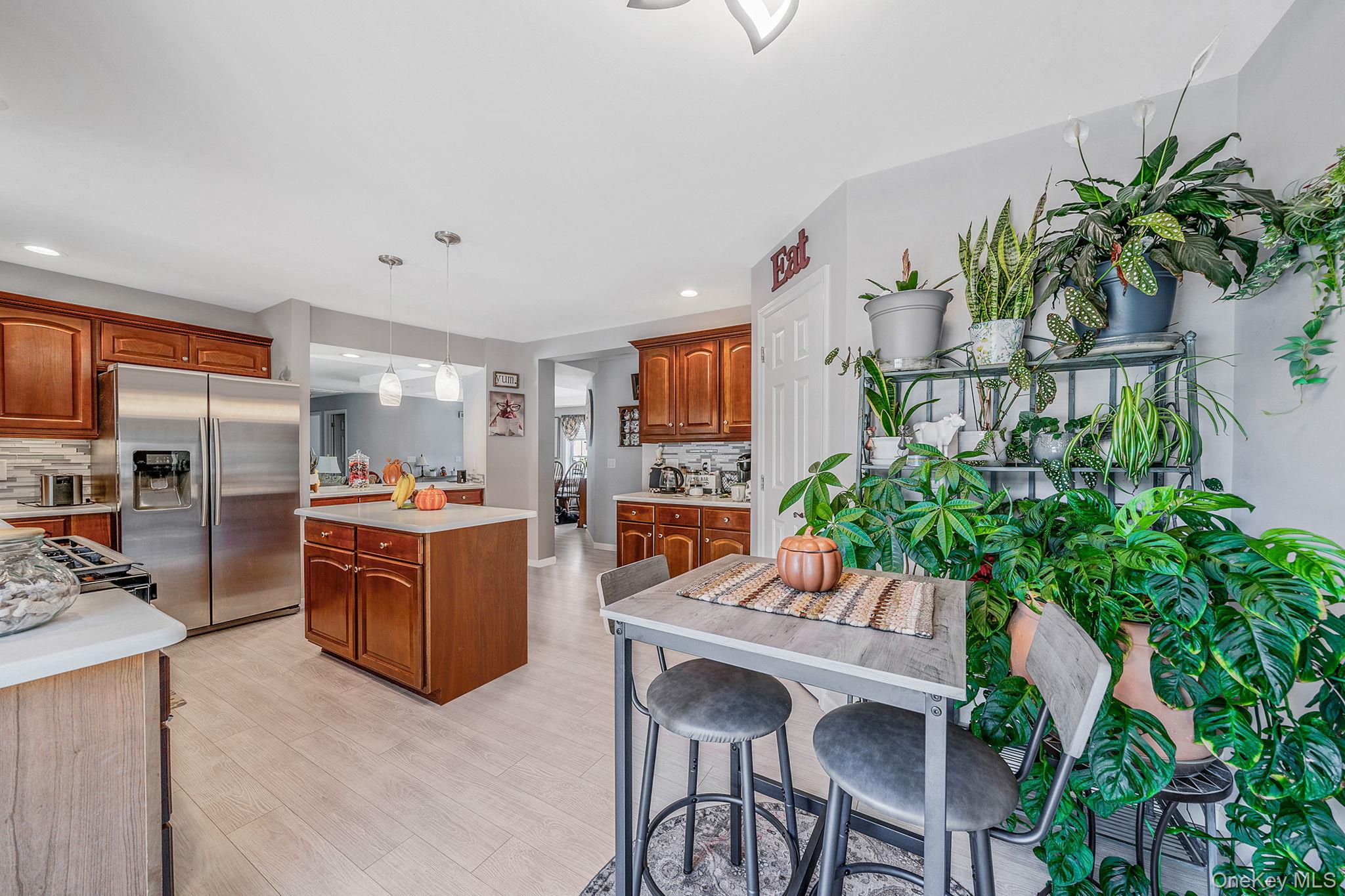 1407 Middle Road, Unit 258 Calverton, NY 11933 - Photo 25 of 50 a living room with furniture potted plant and a flat screen tv