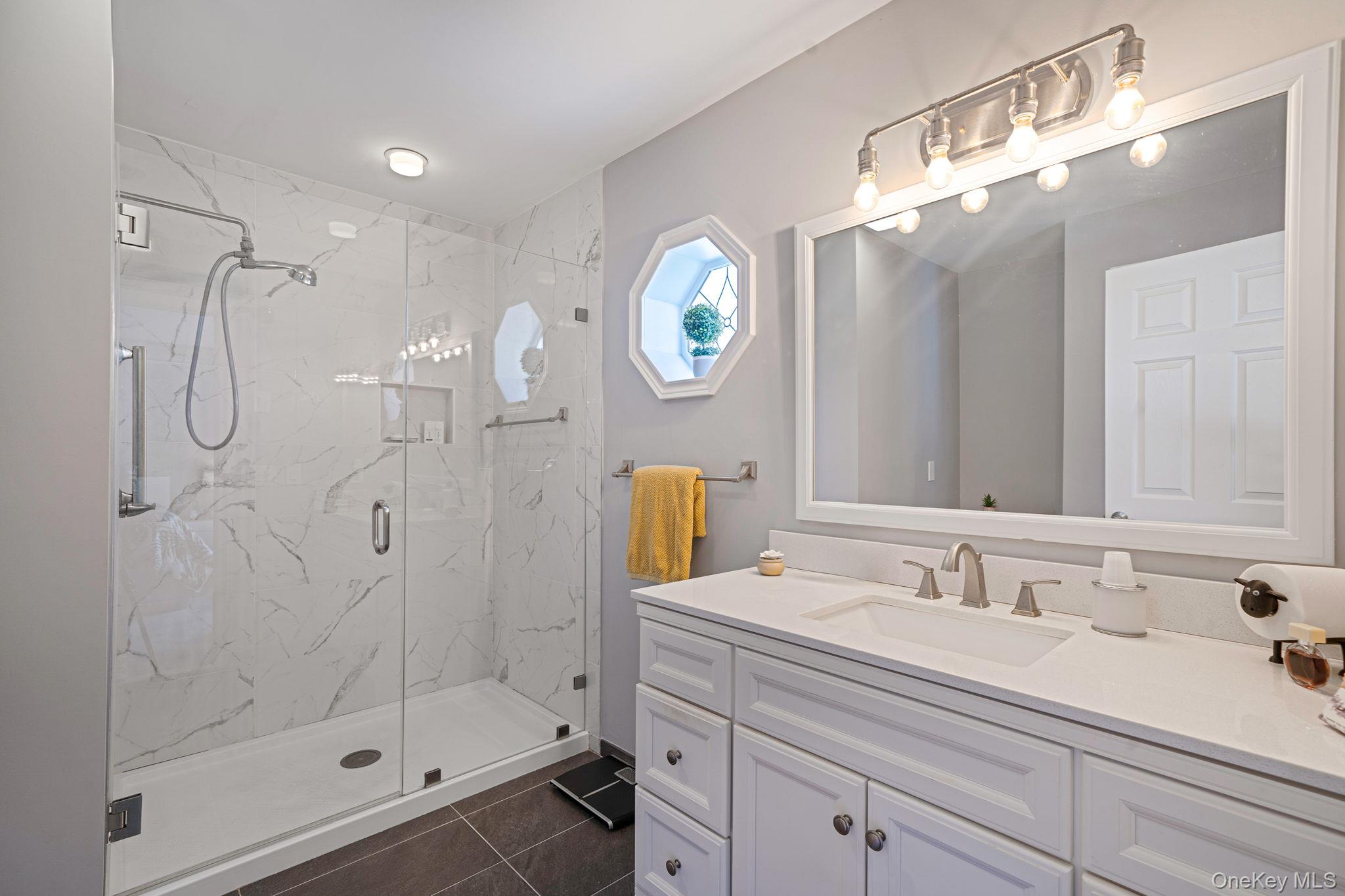 1407 Middle Road, Unit 258 Calverton, NY 11933 - Photo 28 of 50 a bathroom with a sink and a mirror