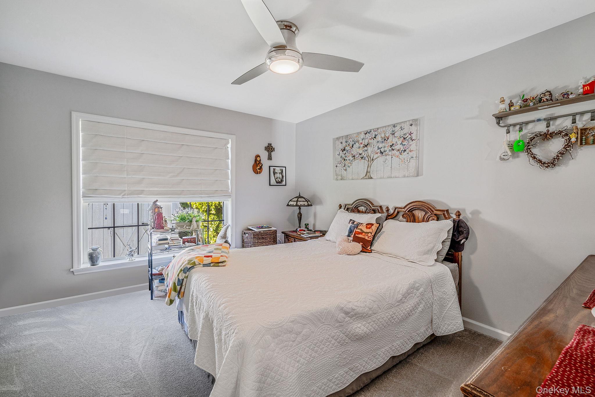 1407 Middle Road, Unit 258 Calverton, NY 11933 - Photo 30 of 50 a bedroom with bed and a window