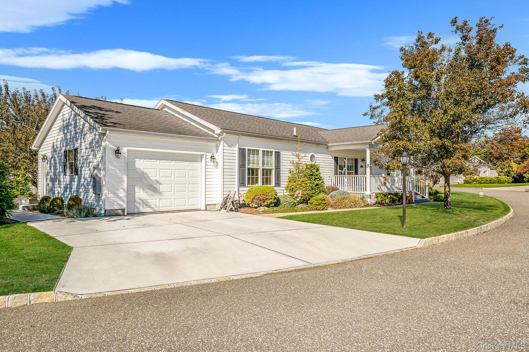 1407 Middle Road, Unit 258 Calverton, NY 11933 - Photo 3 of 50 front view of a house with a yard and potted plants