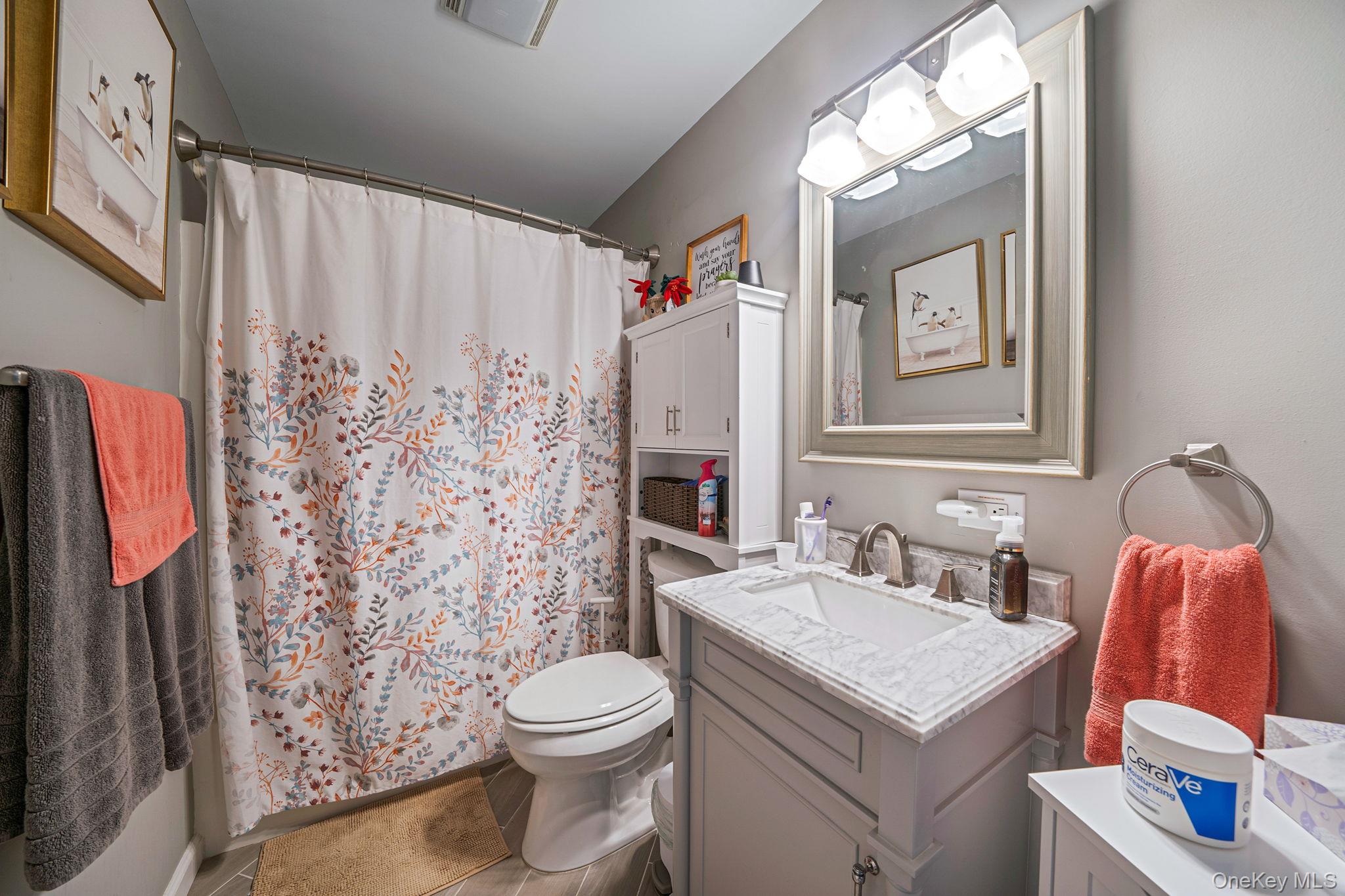 1407 Middle Road, Unit 258 Calverton, NY 11933 - Photo 33 of 50 a bathroom with a sink toilet and shower