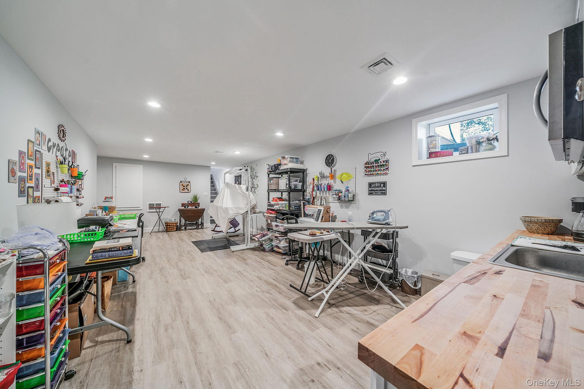 1407 Middle Road, Unit 258 Calverton, NY 11933 - Photo 36 of 50 a view of a dining room with furniture and a wooden floor