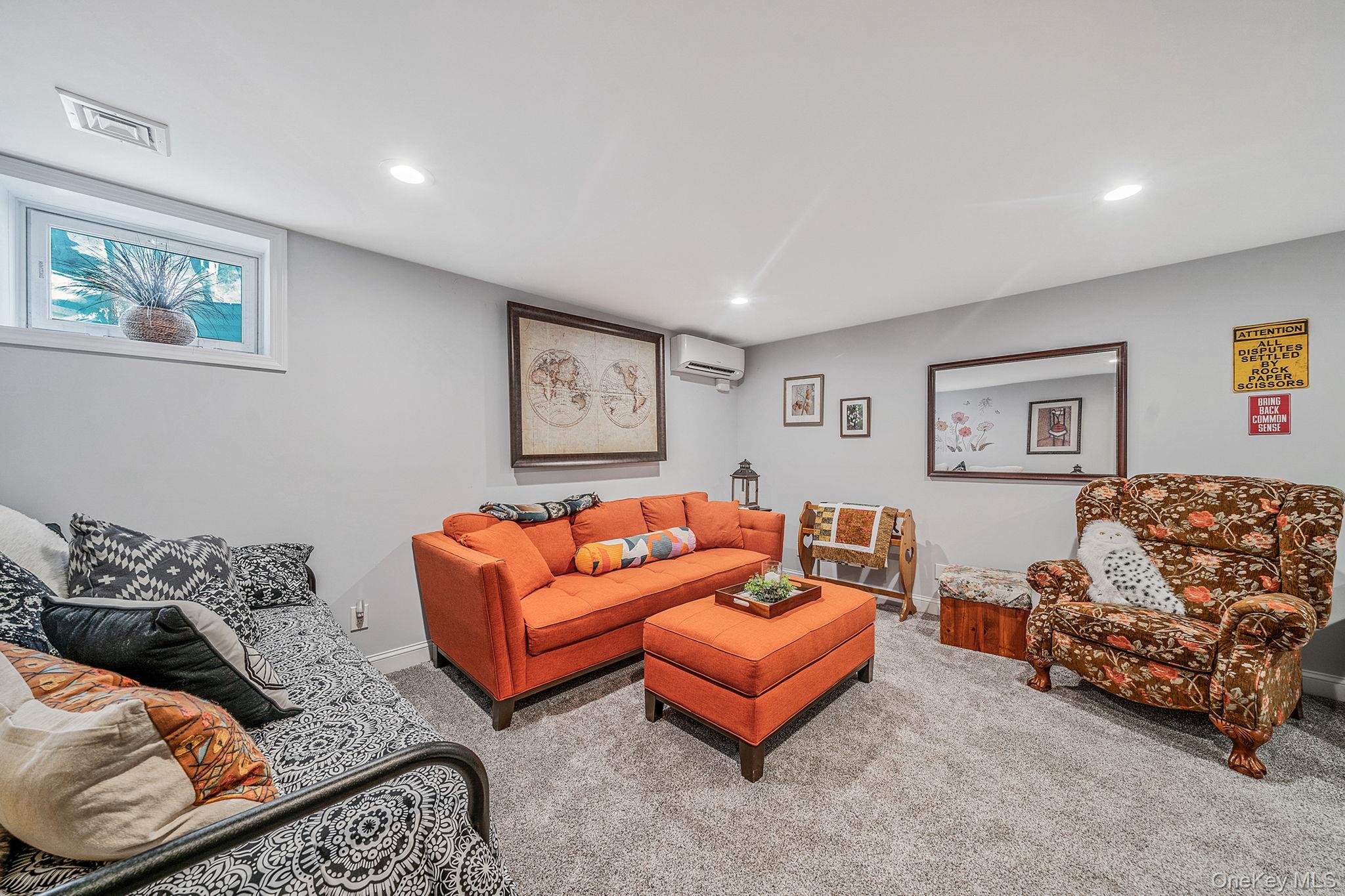 1407 Middle Road, Unit 258 Calverton, NY 11933 - Photo 38 of 50 a living room with furniture and a window