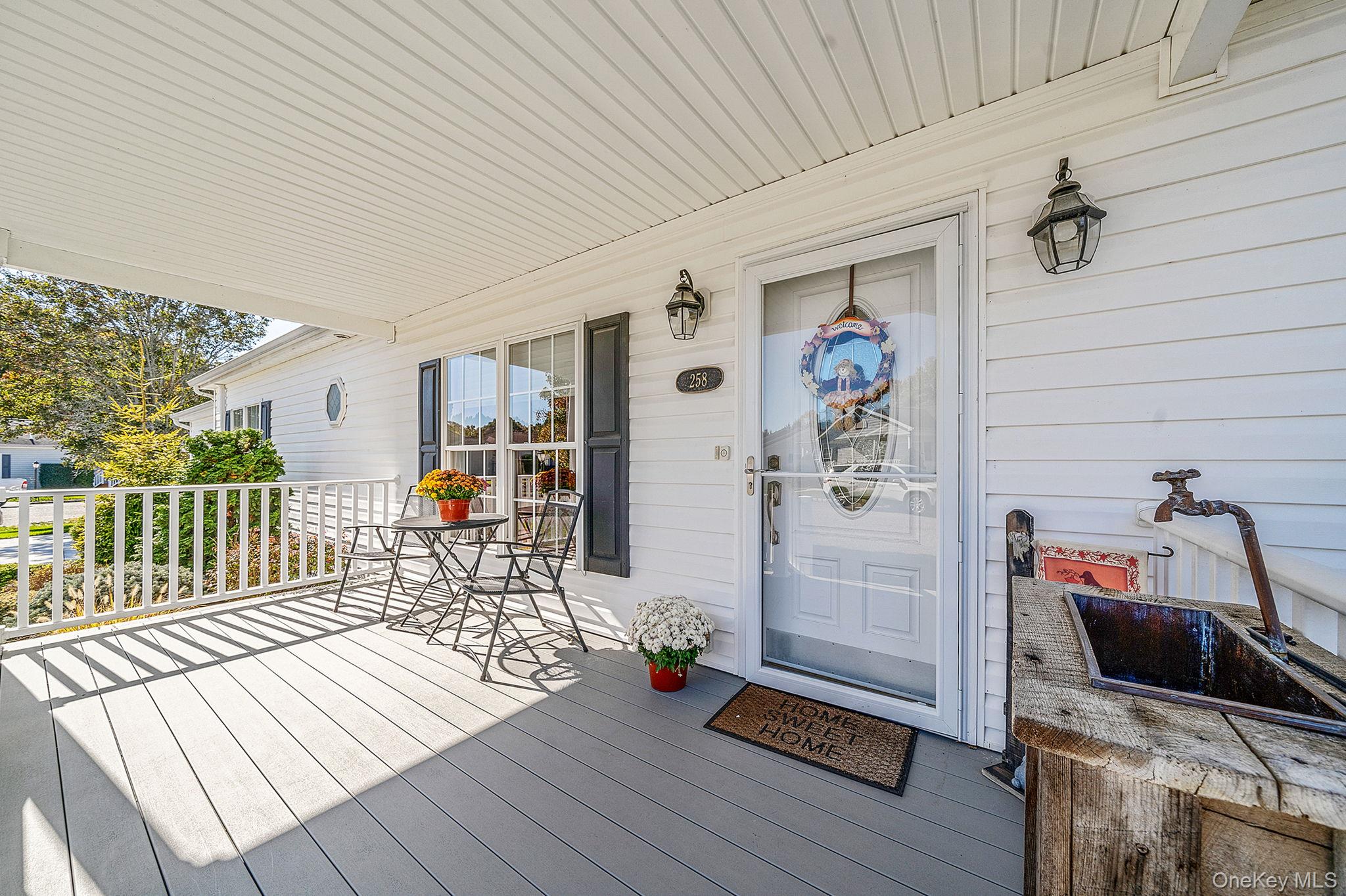 1407 Middle Road, Unit 258 Calverton, NY 11933 - Photo 4 of 50 a living room with furniture and wooden floor