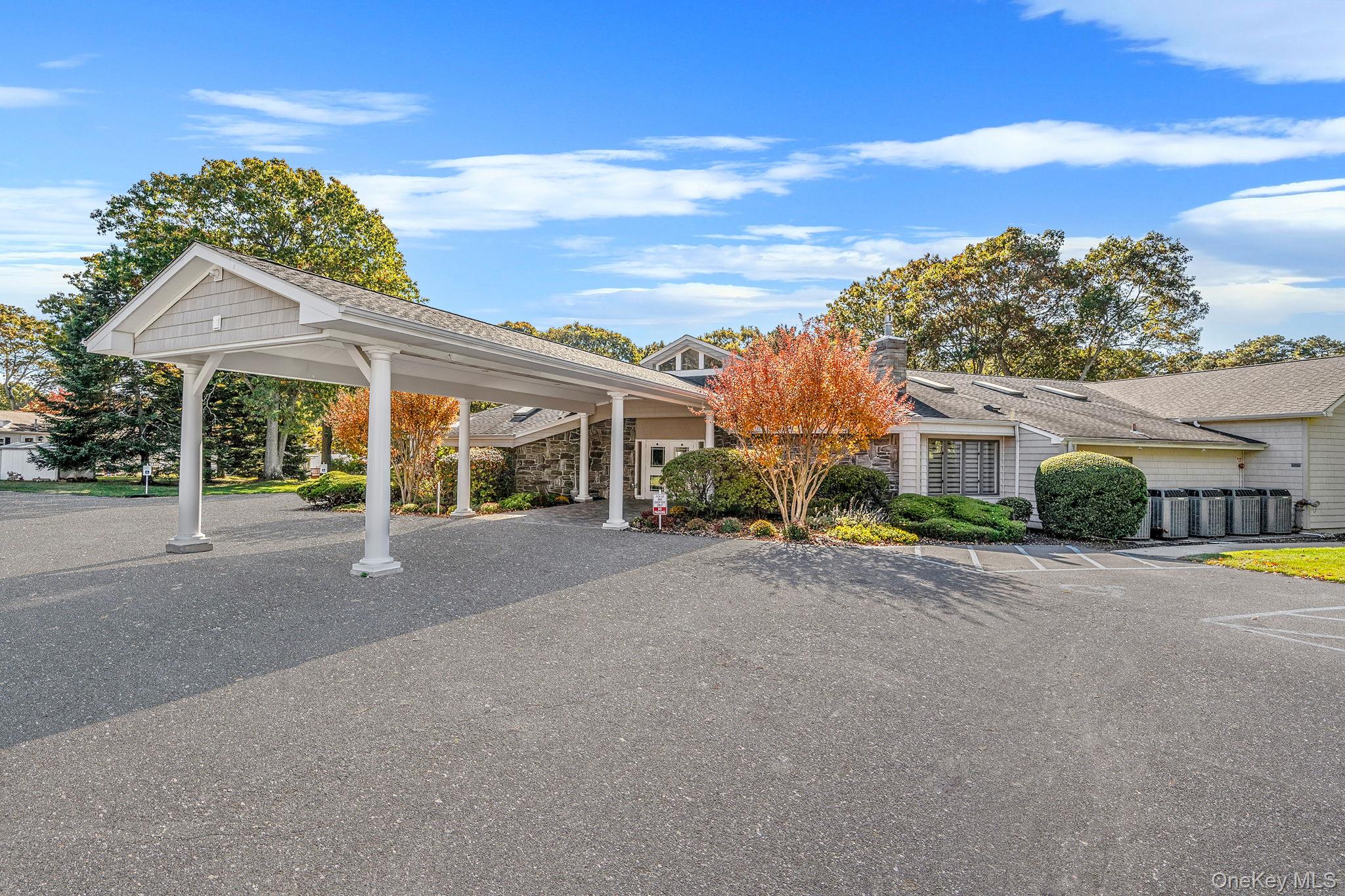 1407 Middle Road, Unit 258 Calverton, NY 11933 - Photo 43 of 50 front view of a house with a garden