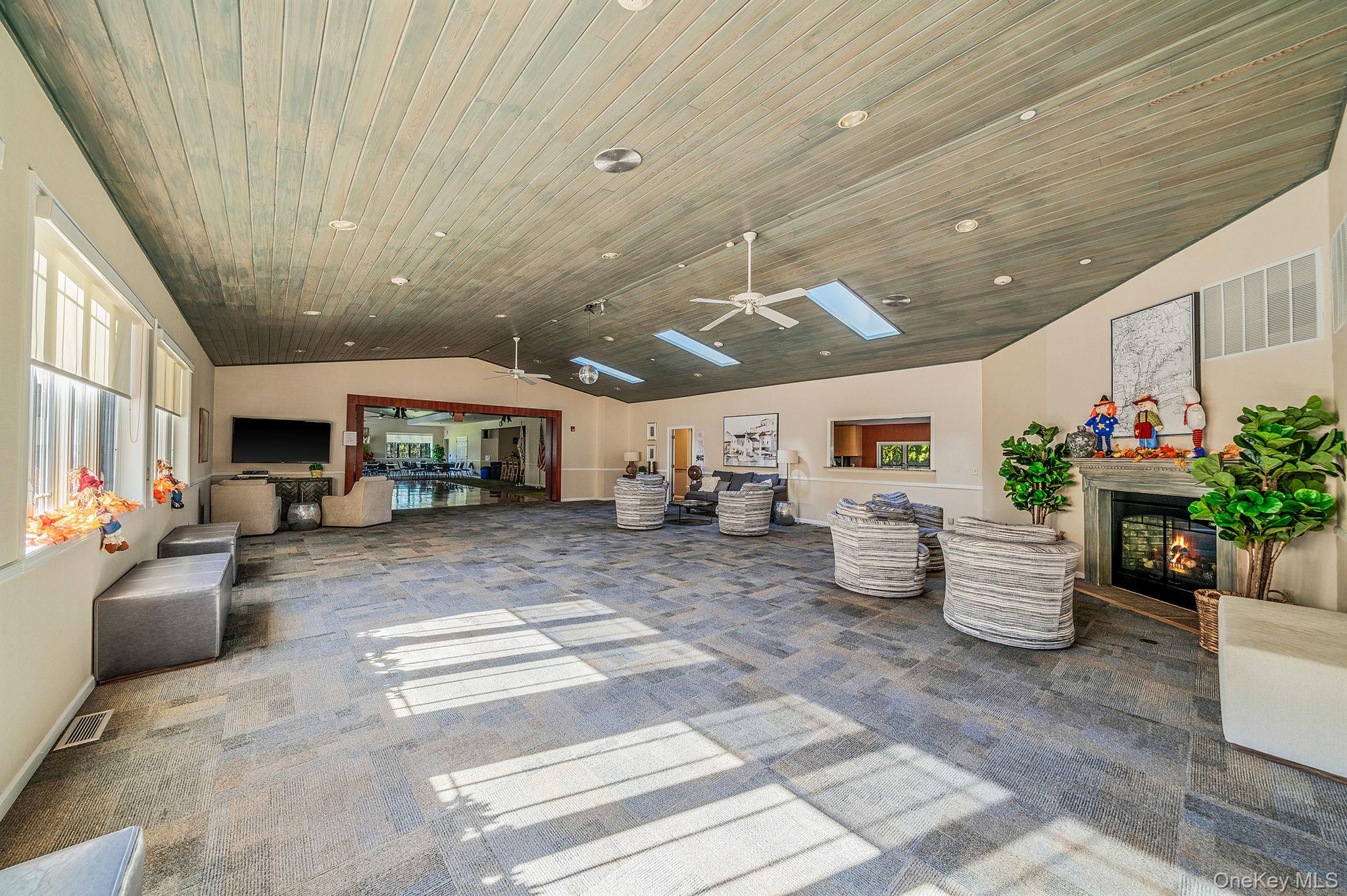 1407 Middle Road, Unit 258 Calverton, NY 11933 - Photo 44 of 50 a living room with furniture and flowers