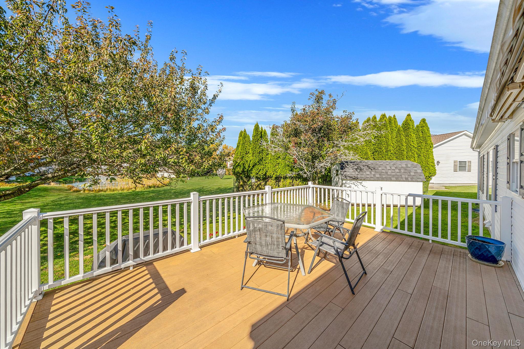 1407 Middle Road, Unit 258 Calverton, NY 11933 - Photo 6 of 50 a view of a balcony with two chairs and a table