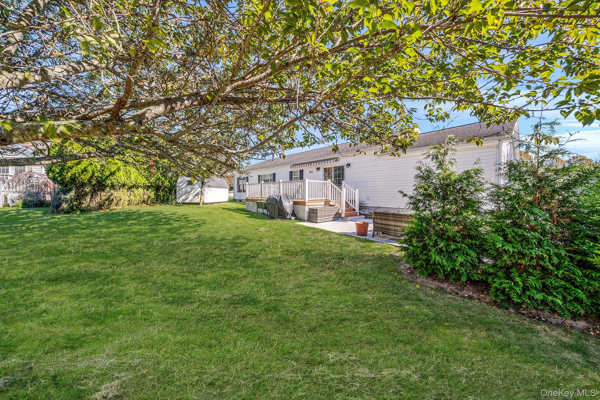 1407 Middle Road, Unit 258 Calverton, NY 11933 - Photo 8 of 50 a house view with a garden space