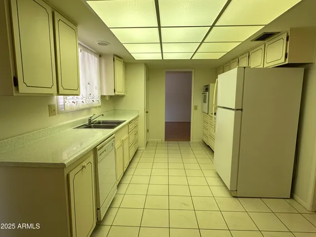 a kitchen with a sink cabinets and a refrigerator