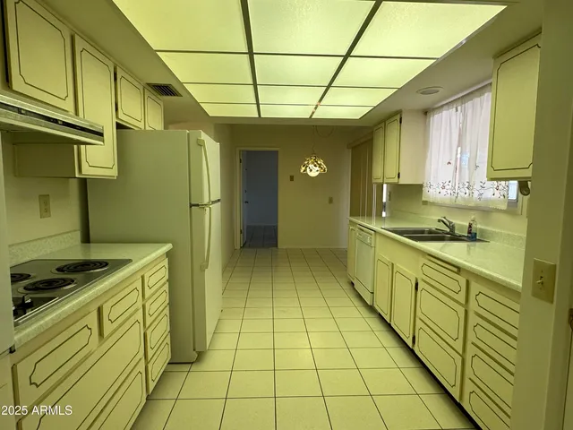 a kitchen with stainless steel appliances granite countertop a sink and cabinets