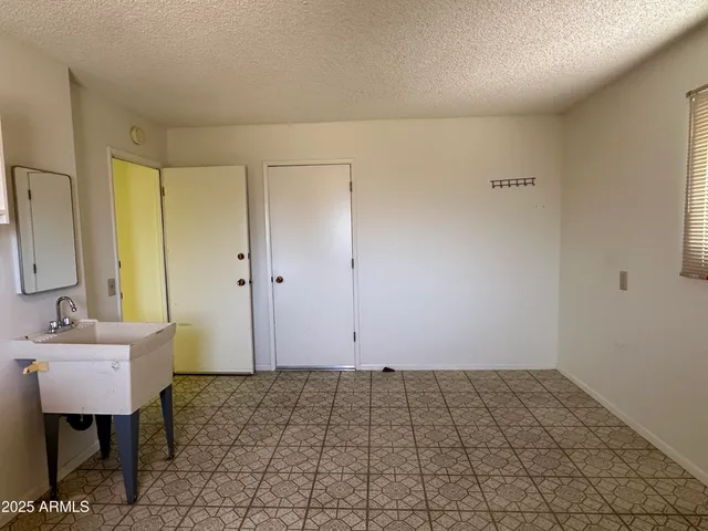 a view of a room with a sink and a mirror