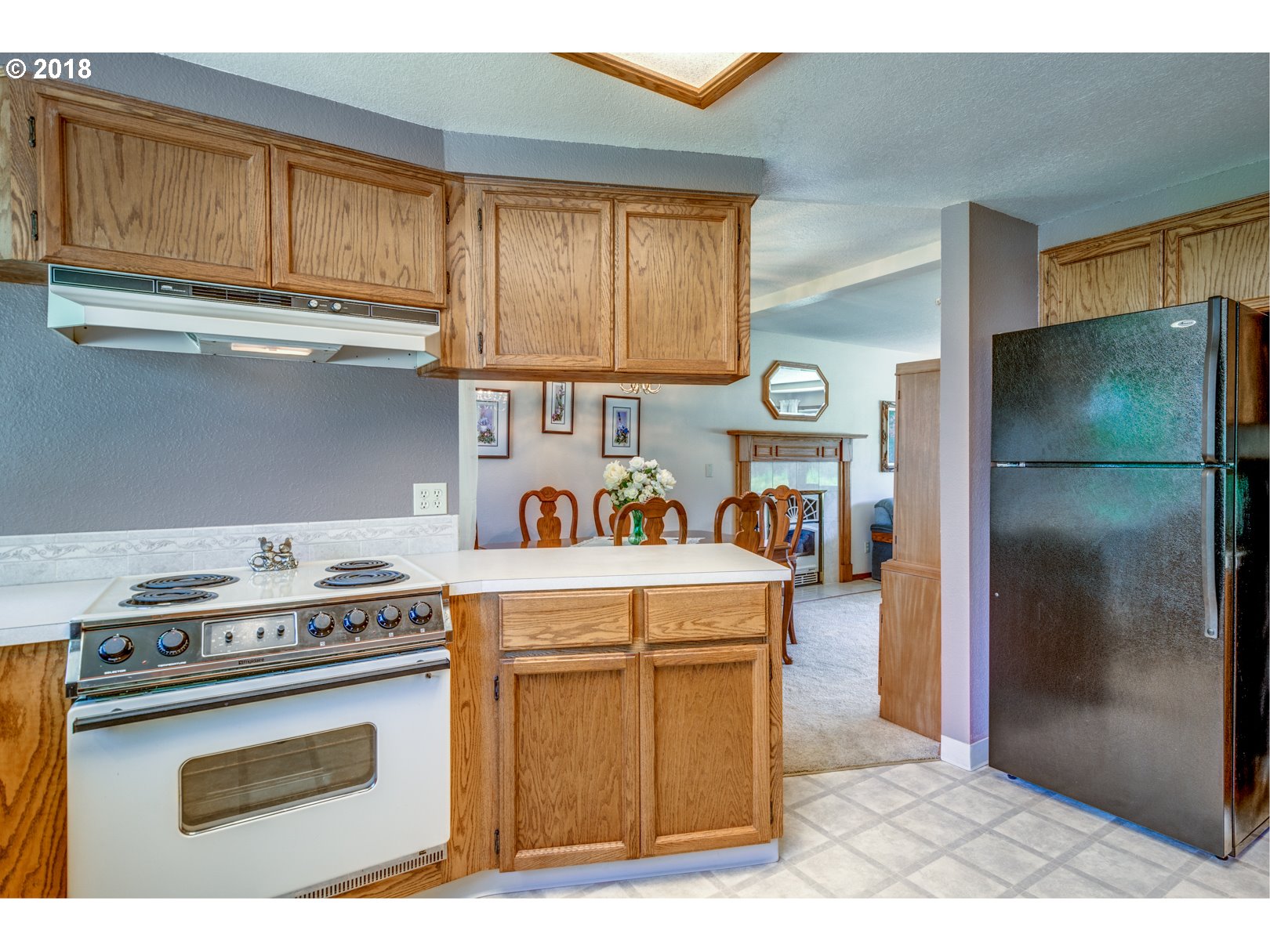 35133 Southeast Homan Road Gresham, OR 97080 - Photo 5 of 32 a kitchen with a stove a refrigerator and cabinets