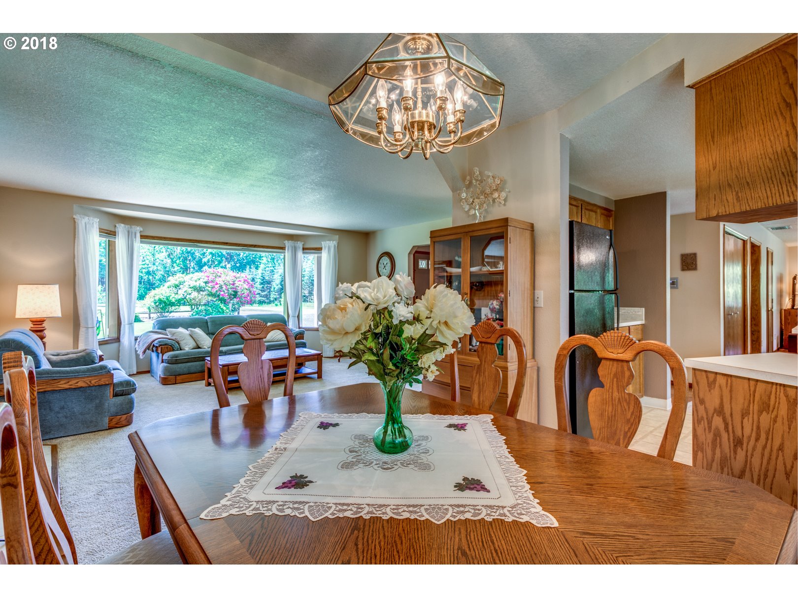 35133 Southeast Homan Road Gresham, OR 97080 - Photo 10 of 32 a view of a dining room with furniture a chandelier and large windows