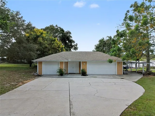 a white house that has a tree in front of it