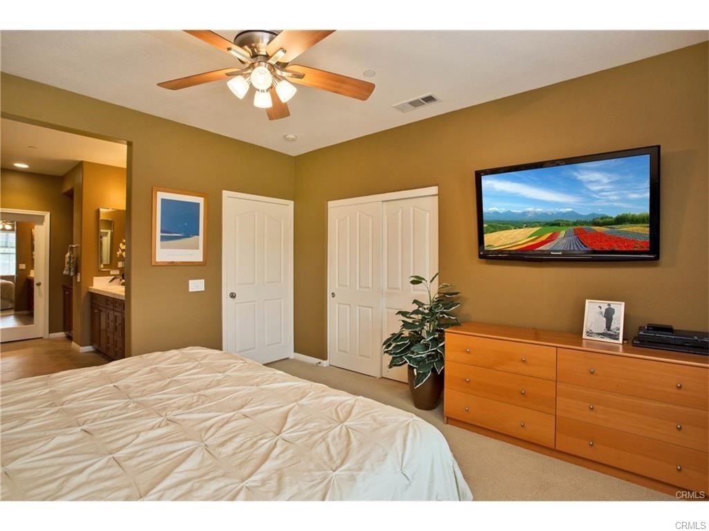 21 Corte Javier San Clemente, CA 92673 - Photo 17 of 32 a bedroom with a bed and a chandelier