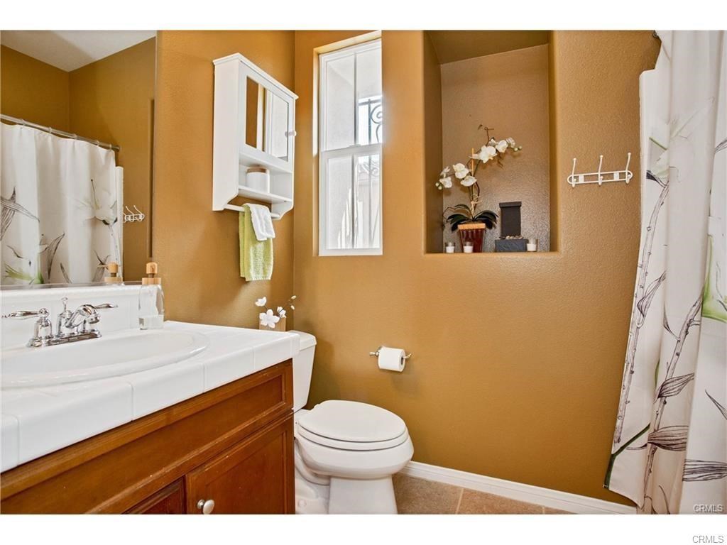 21 Corte Javier San Clemente, CA 92673 - Photo 21 of 32 a bathroom with a sink a toilet and shower curtain