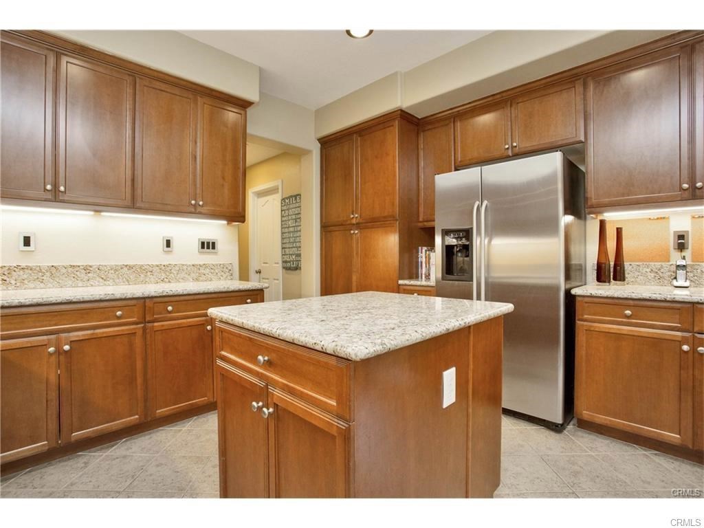 21 Corte Javier San Clemente, CA 92673 - Photo 4 of 32 a kitchen with stainless steel appliances granite countertop a sink a refrigerator and cabinets