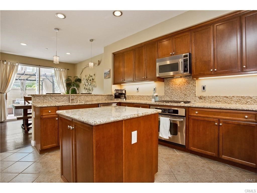 21 Corte Javier San Clemente, CA 92673 - Photo 5 of 32 a kitchen with granite countertop stainless steel appliances and wooden cabinets