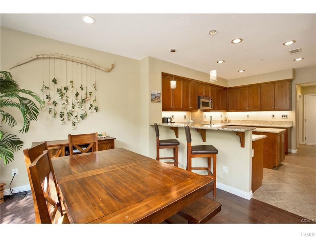 21 Corte Javier San Clemente, CA 92673 - Photo 6 of 32 a kitchen with stainless steel appliances kitchen island granite countertop a sink and cabinets