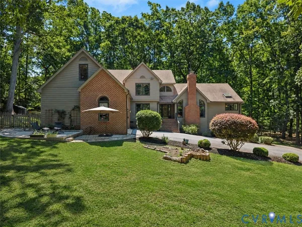 a aerial view of a house with backyard and sitting area