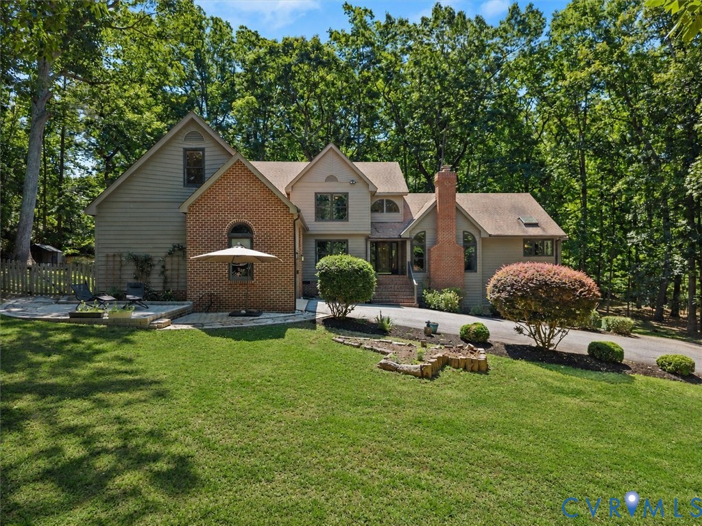 a aerial view of a house with backyard and sitting area