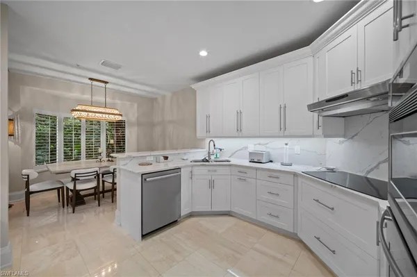 a kitchen with sink and white cabinets