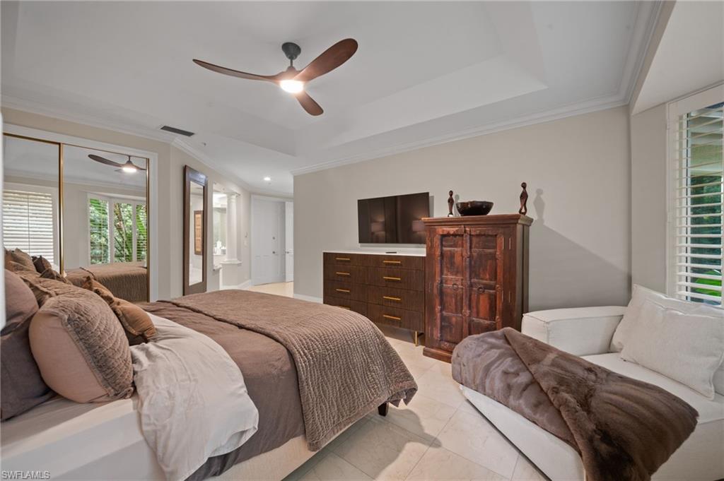 261 Colonade Circle, Unit 2701 Naples, FL 34103 - Photo 19 of 49 a bedroom with a bed dresser and a window