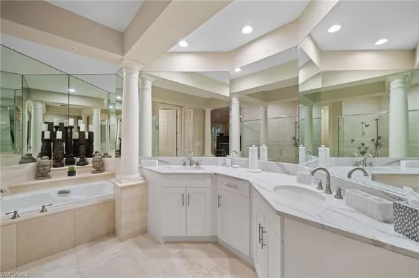 a large bathroom with a double vanity sink and mirror with shower