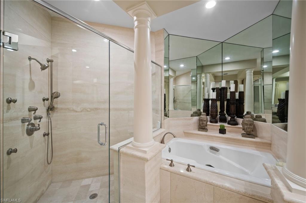 261 Colonade Circle, Unit 2701 Naples, FL 34103 - Photo 23 of 49 a bathroom with a sink mirror and shower