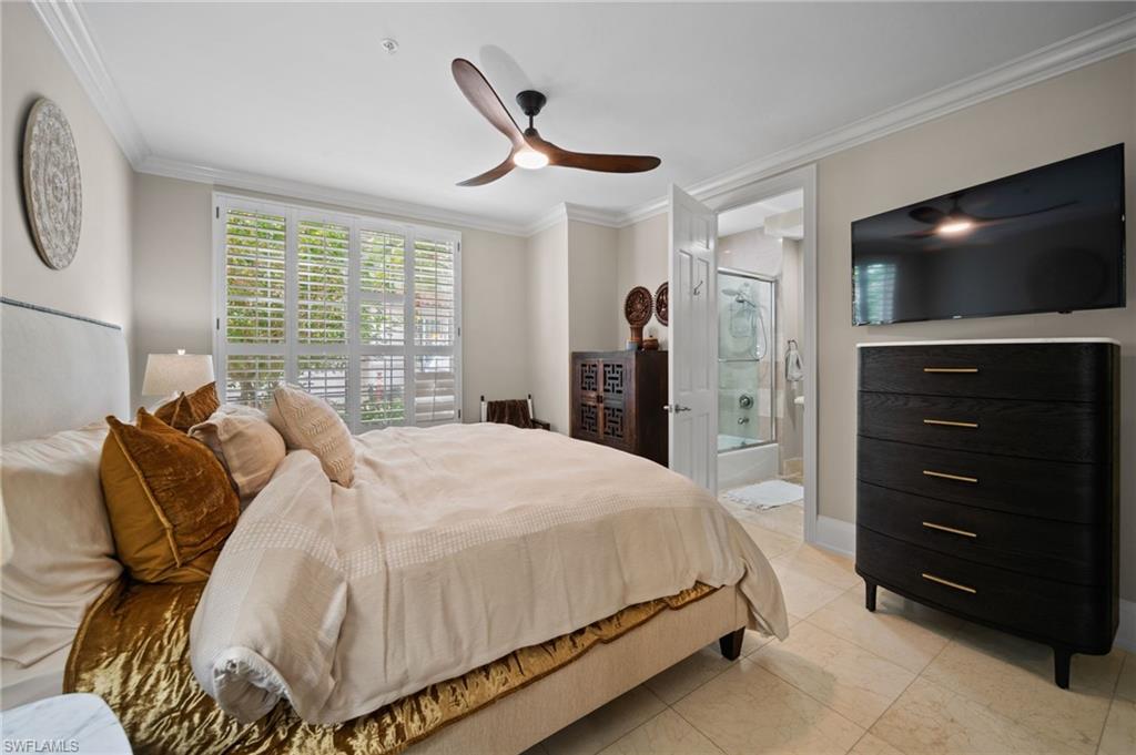 261 Colonade Circle, Unit 2701 Naples, FL 34103 - Photo 25 of 49 a bedroom with a bed and a flat screen tv