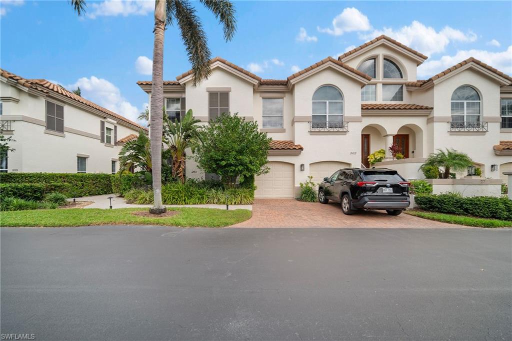 261 Colonade Circle, Unit 2701 Naples, FL 34103 - Photo 37 of 49 a couple of cars parked in front of a house