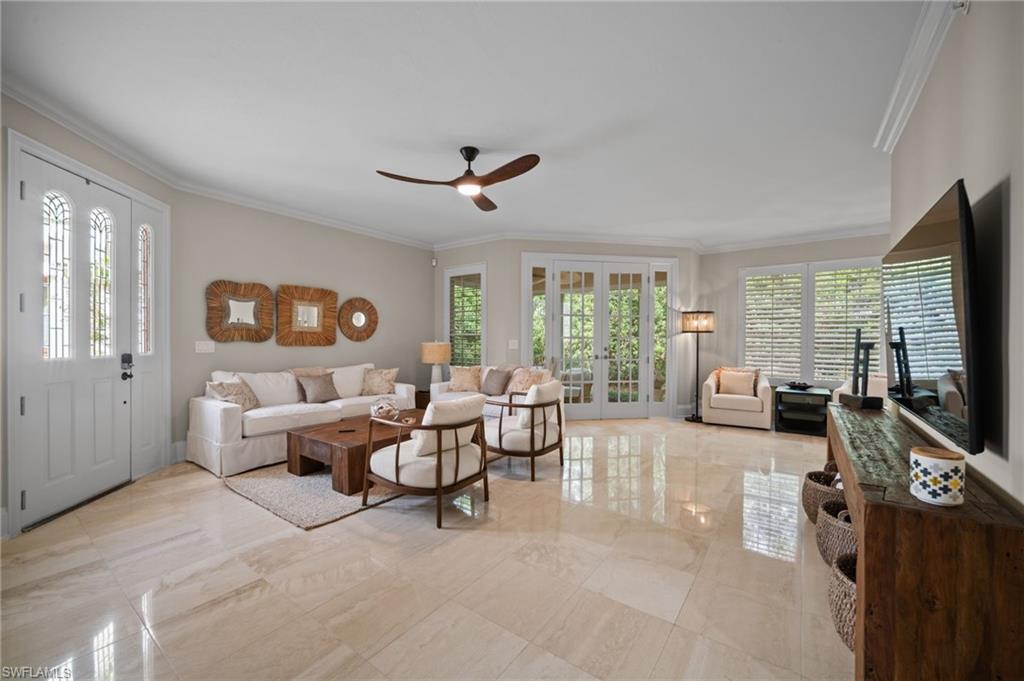 261 Colonade Circle, Unit 2701 Naples, FL 34103 - Photo 4 of 49 a living room with furniture large window and flat screen tv