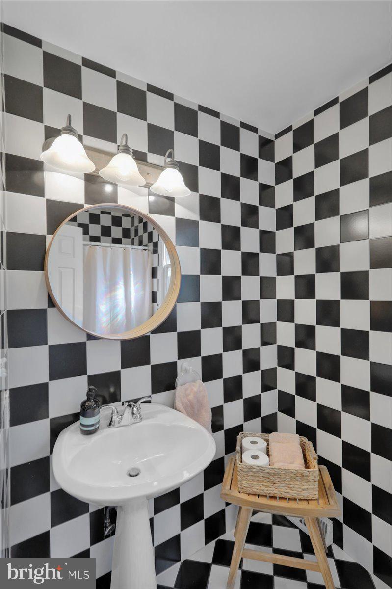 208 Queens Gate Road Lititz, PA 17543 - Photo 27 of 49 a view of a black and white checkered floor with a dining table