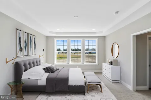 a bedroom with a bed mirror and window