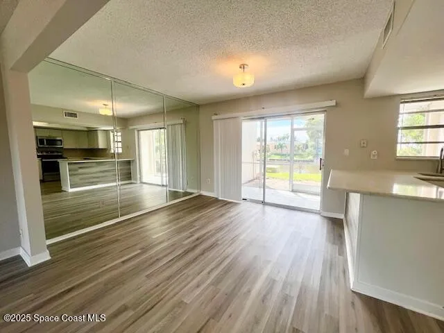 a view of an empty room and wooden floor