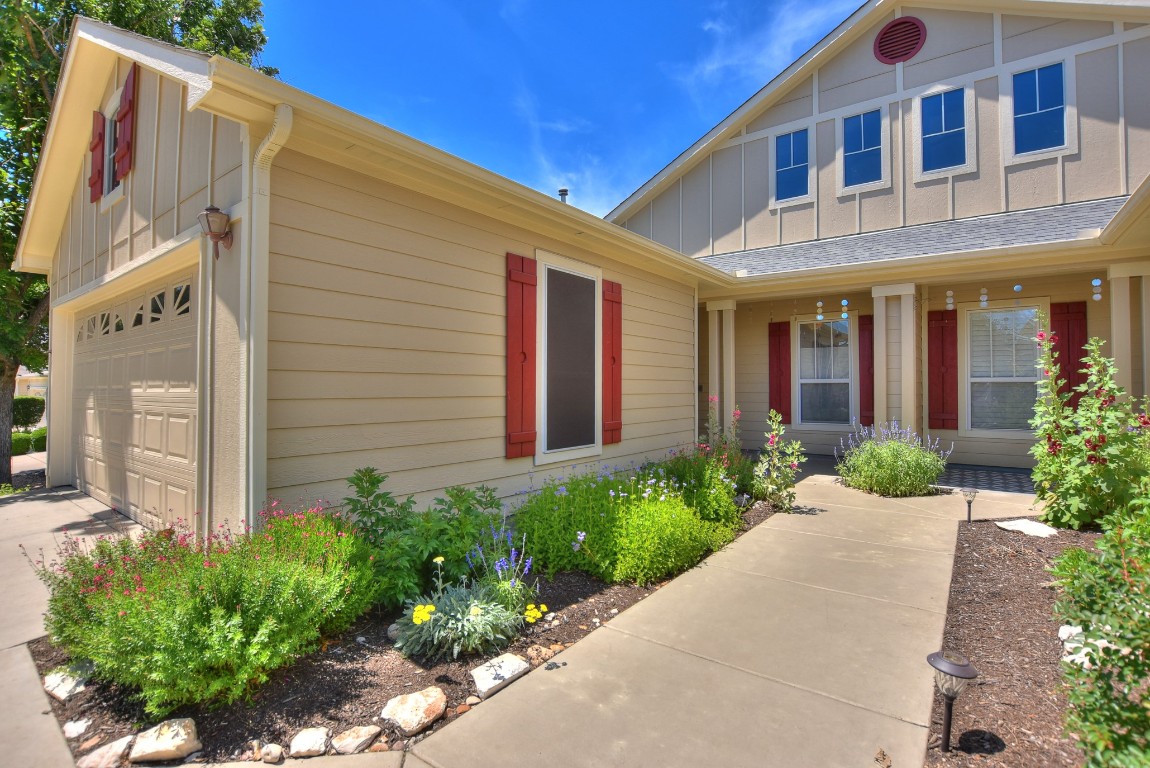 a view of a brick house with potted plants