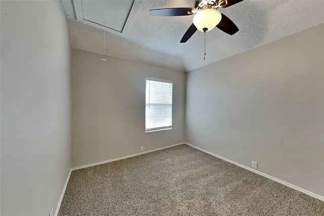 a view of room with window and a ceiling fan