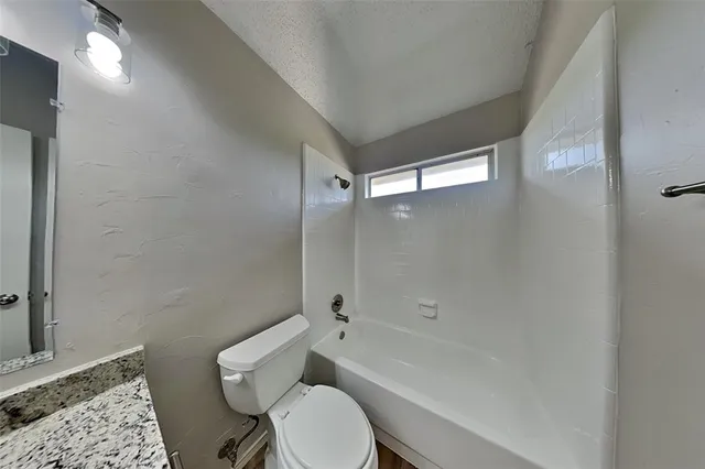 a bathroom with a toilet a sink and shower