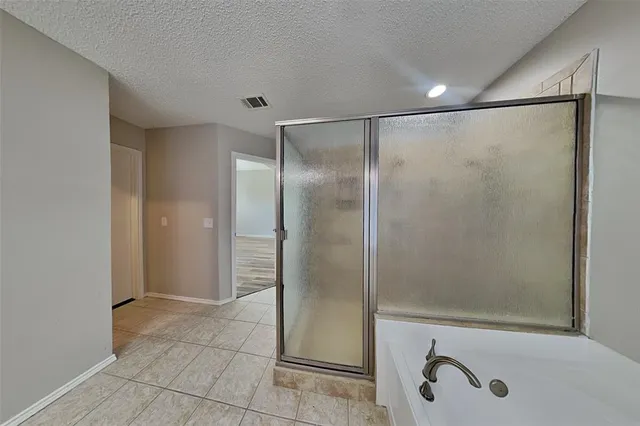 a bathroom with a shower and a tub