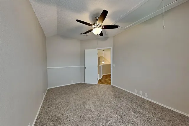 an empty room with closet and windows