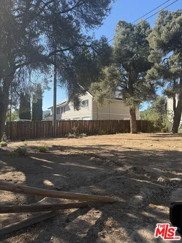 a swimming pool view with large trees