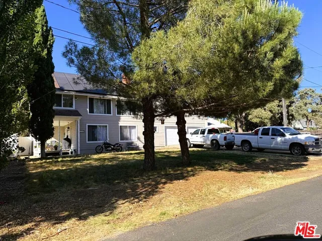 a front view of a house with a yard table and chairs