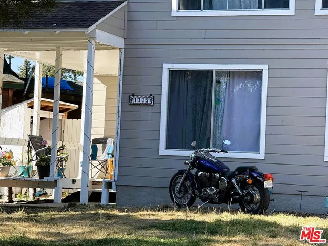 a view of a house with a small yard and a fountain
