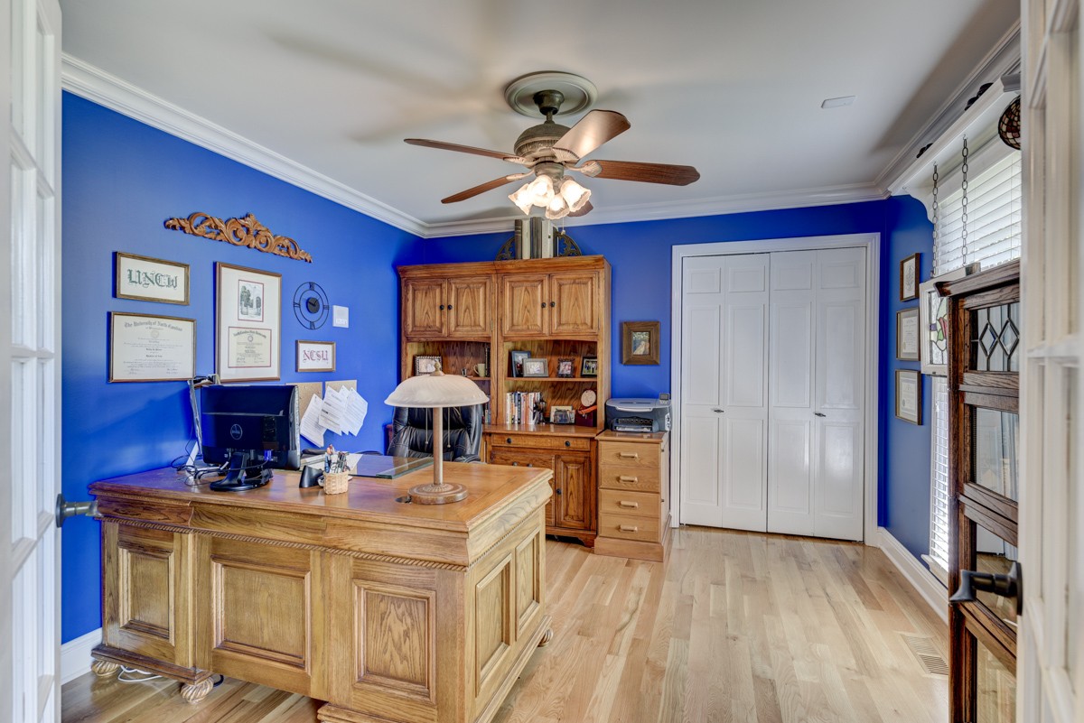1069 Edgewater Circle Gallatin, TN 37066 - Photo 22 of 43 a view of living room with kitchen island stainless steel appliances furniture a fireplace and a chandelier